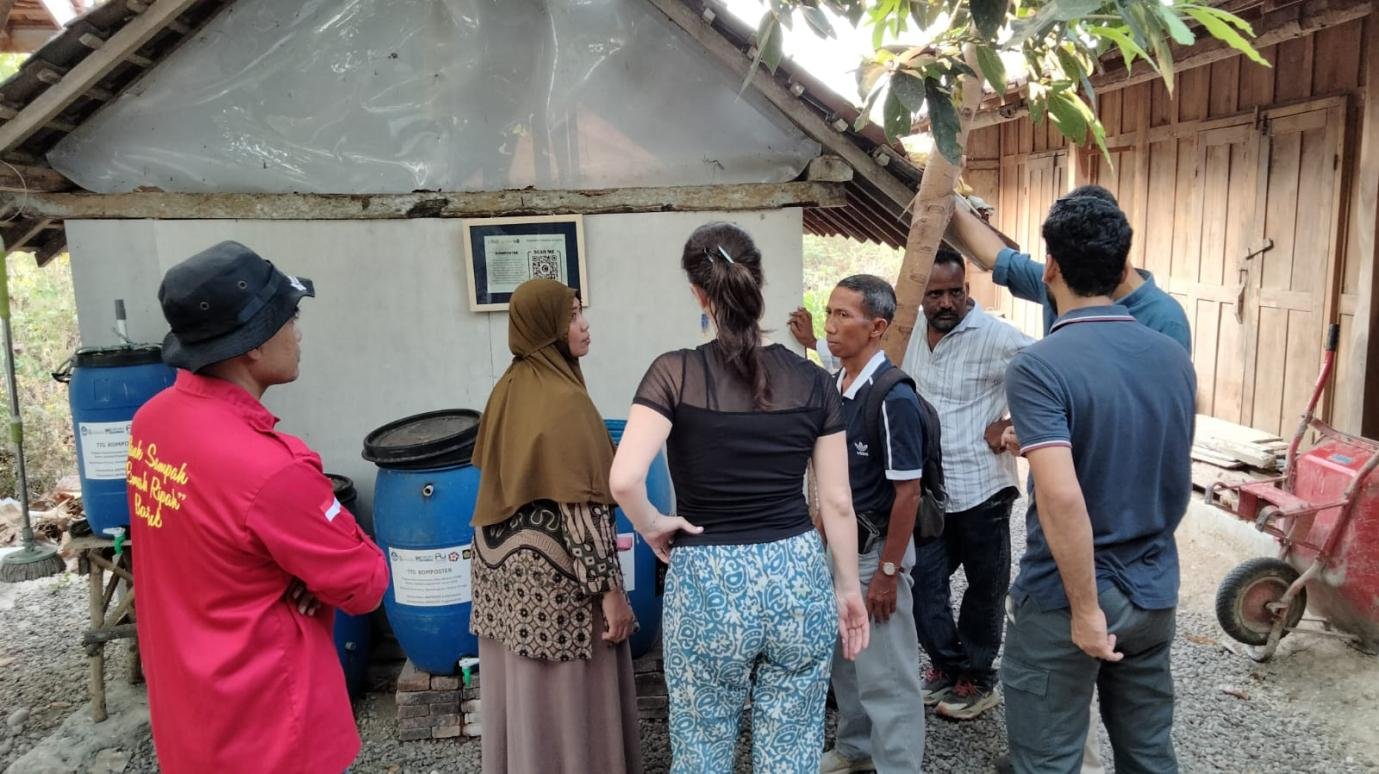 Direktur Bank Sampah Induk Dhuawar Sejahtera Febriyanti menjelaskan sistem pengomposan TTG Komposter kepada Emilia Szekely dan tim Barefoot College